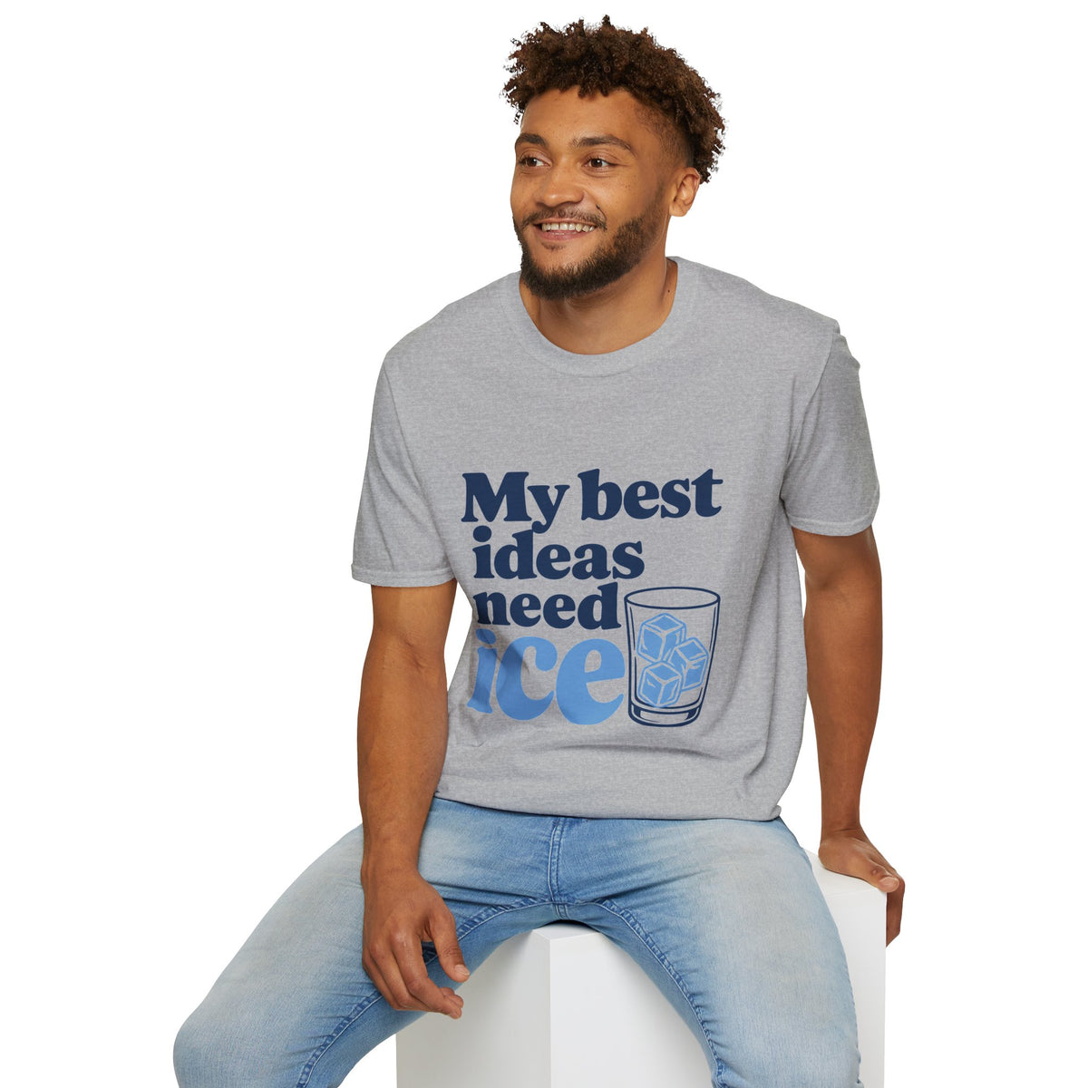 My Best Ideas Need Ice Shirt, Sport Grey, worn by a model seated on a white block