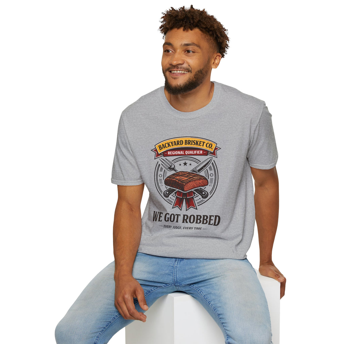 Backyard Brisket Co. Shirt, Sport Grey, worn by a model seated on a white block
