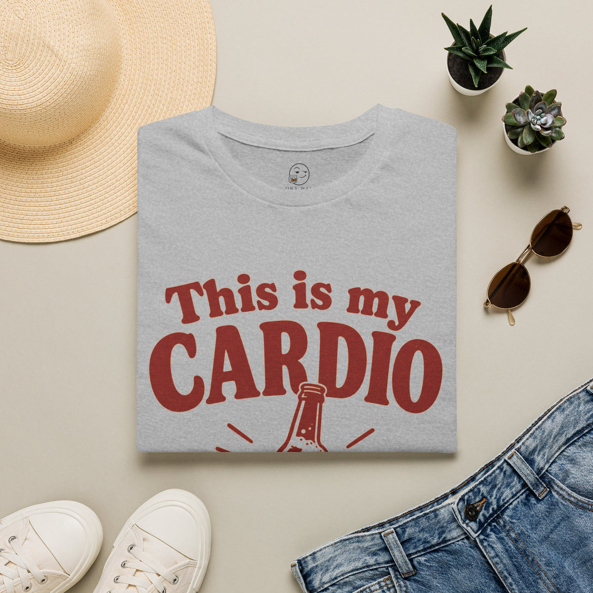 This Is My Cardio Shirt, Sport Grey, folded flat lay styled with a straw hat, sunglasses, sneakers and denim