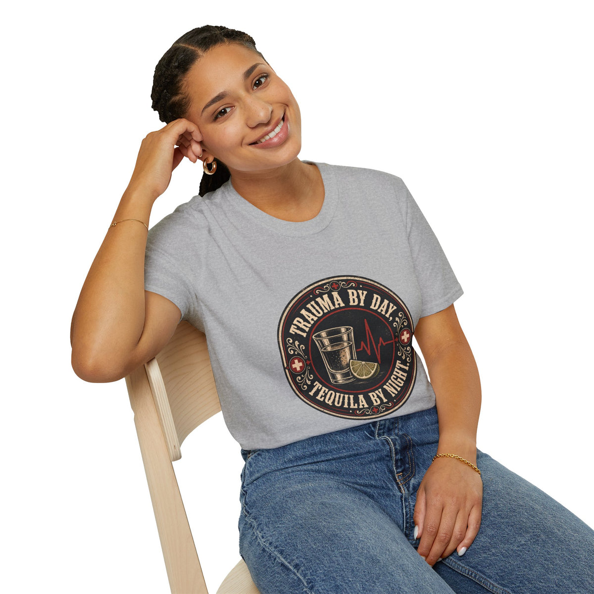 Trauma by Day, Tequila by Night Shirt, Sport Grey, worn by a model seated on a wooden chair