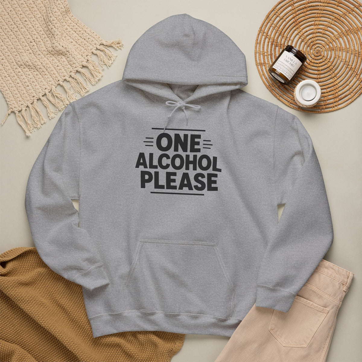 One Alcohol Please funny drinking hoodie, Sport Grey, flat lay styled with a knit throw, candle and tan trousers