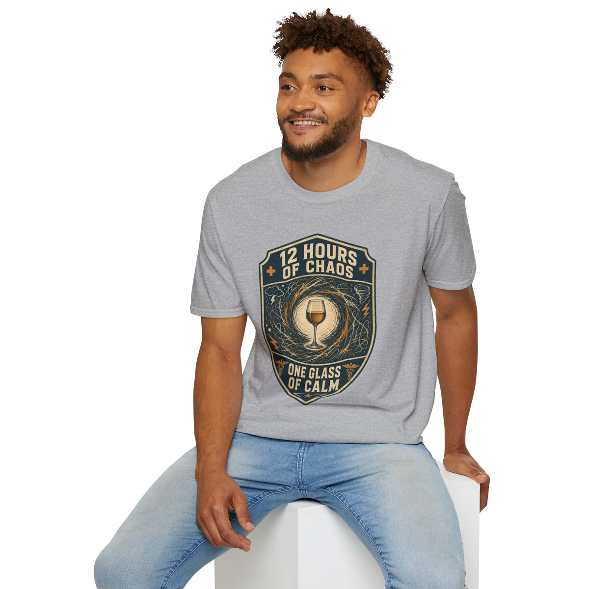 12 Hours of Chaos Shirt, Sport Grey, worn by a model seated on a white block
