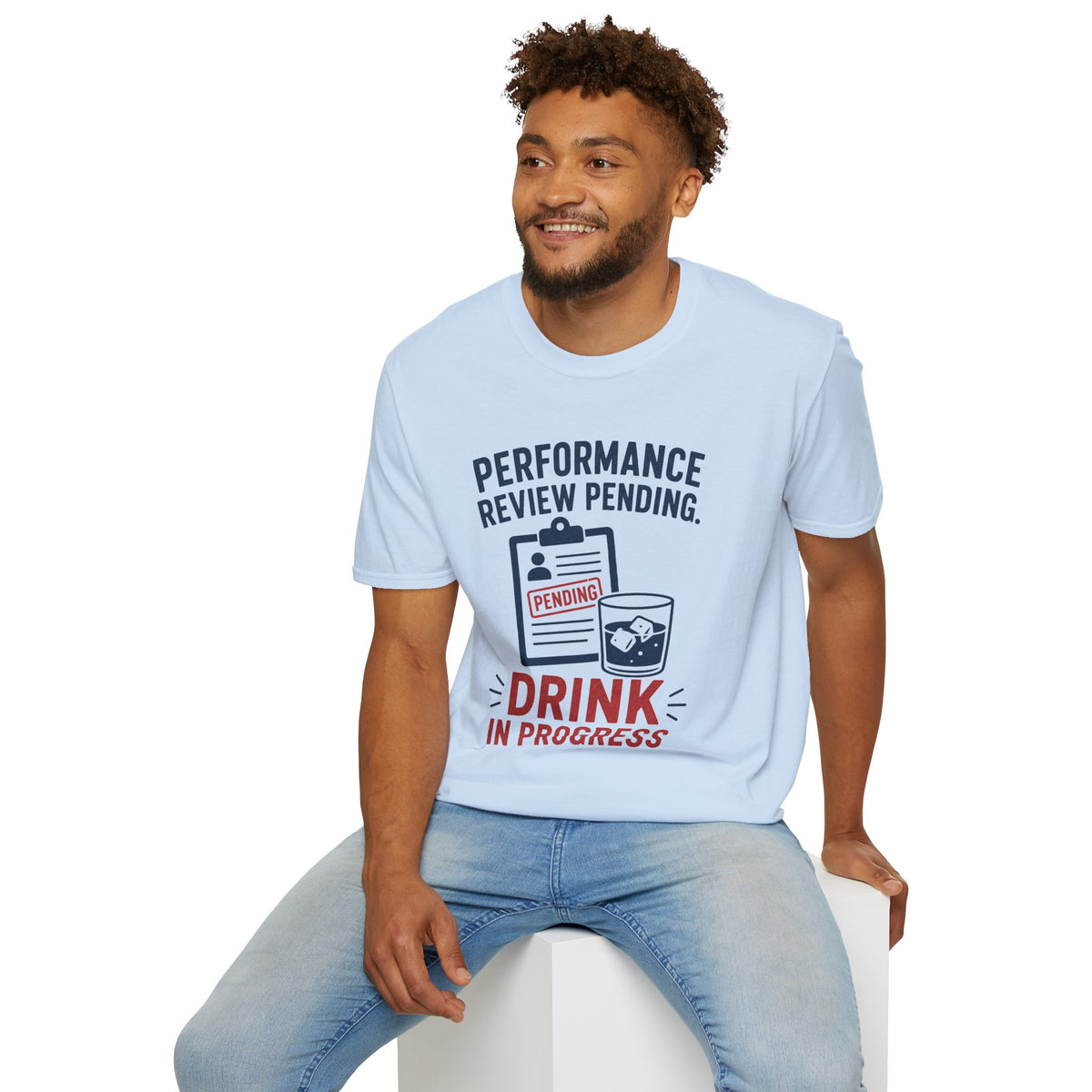 Performance Review Pending Shirt, Light Blue, worn by a model seated on a white block