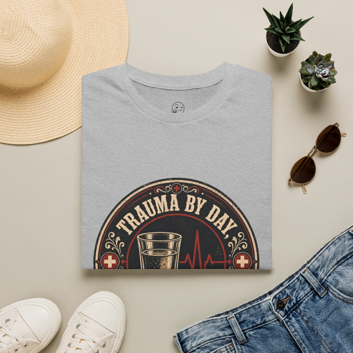 Trauma by Day, Tequila by Night Shirt, Sport Grey, folded flat lay styled with a straw hat, sunglasses, sneakers and denim