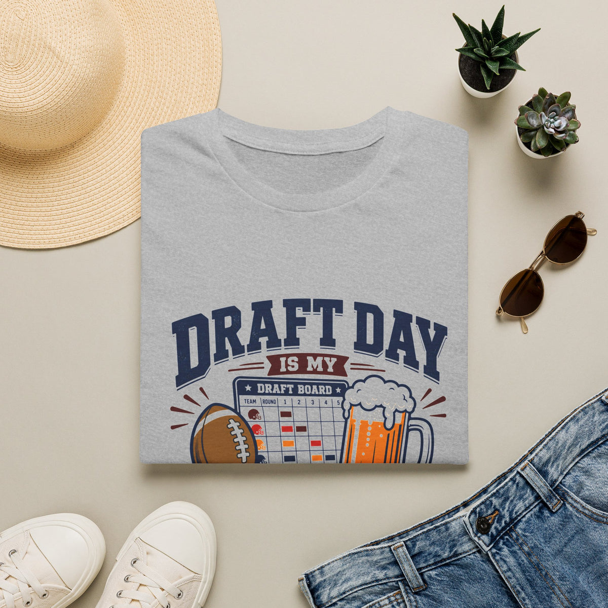 Draft Day Shirt, Sport Grey, folded flat lay styled with a straw hat, sunglasses, sneakers and denim