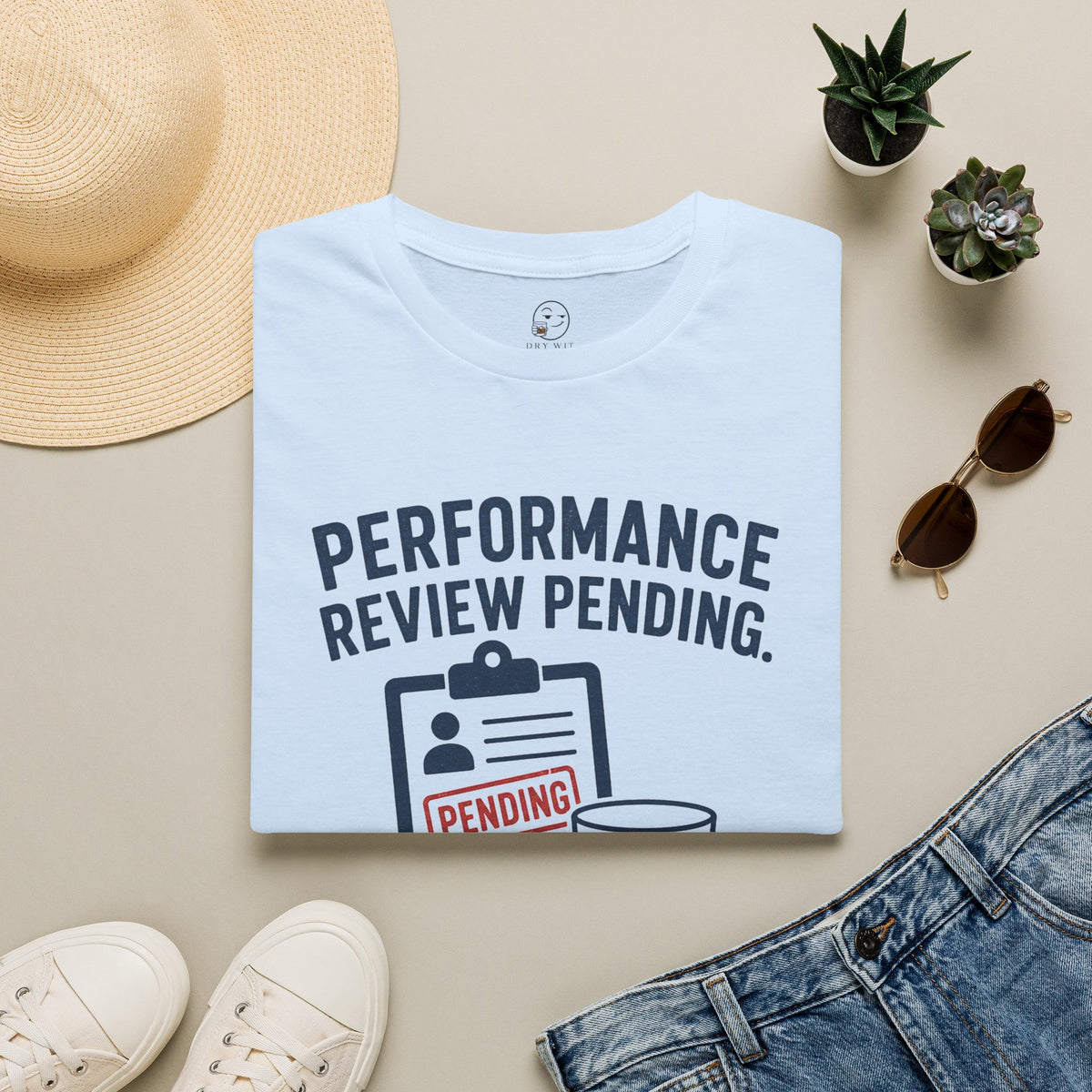 Performance Review Pending Shirt, Light Blue, folded flat lay styled with a straw hat, sunglasses, sneakers and denim