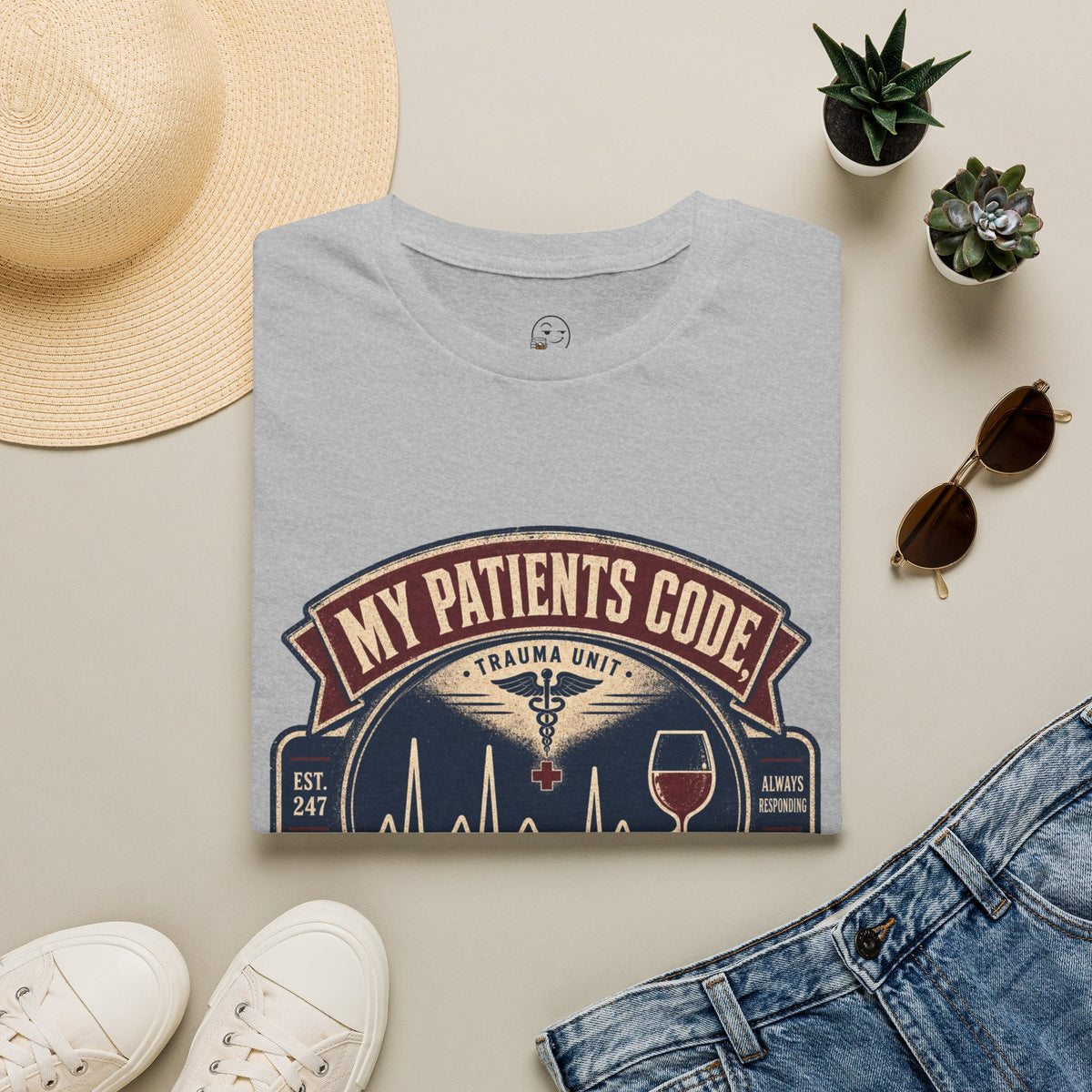 My Patients Code, I Cope Shirt, Sport Grey, folded flat lay styled with a straw hat, sunglasses, sneakers and denim
