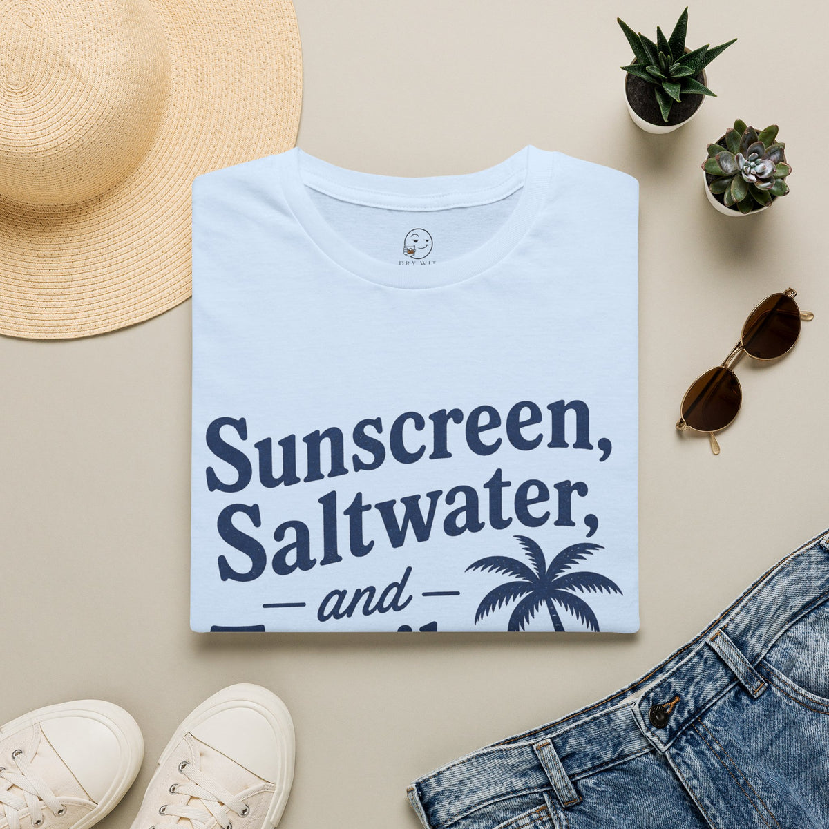 Sunscreen, Saltwater and Tequila Shirt, Light Blue, folded flat lay styled with a straw hat, sunglasses, sneakers and denim