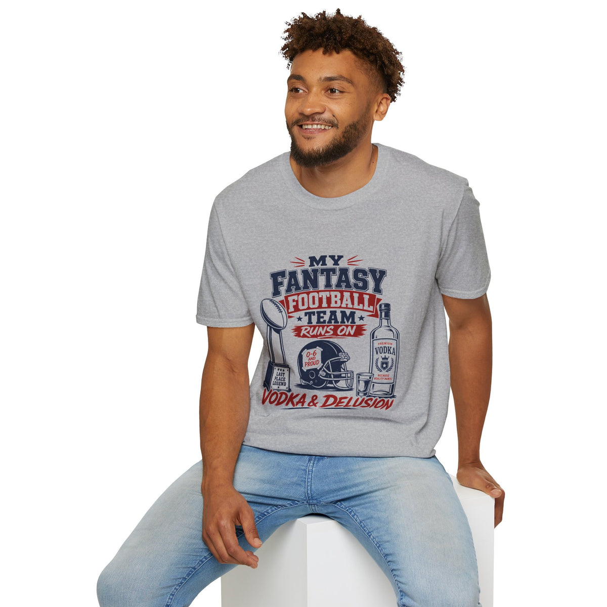 My Team Runs on Delusion Shirt, Sport Grey, worn by a model seated on a white block