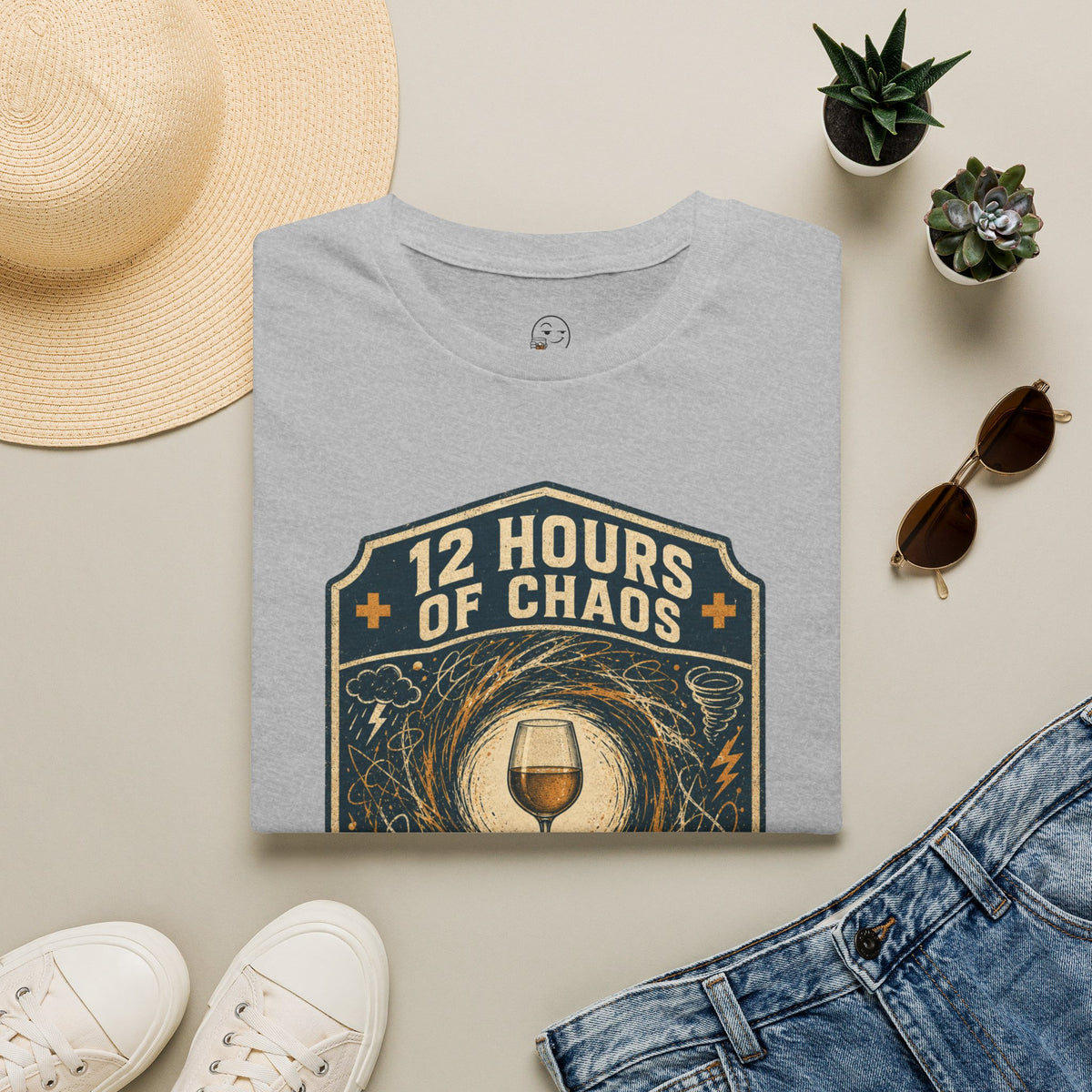 12 Hours of Chaos Shirt, Sport Grey, folded flat lay styled with a straw hat, sunglasses, sneakers and denim