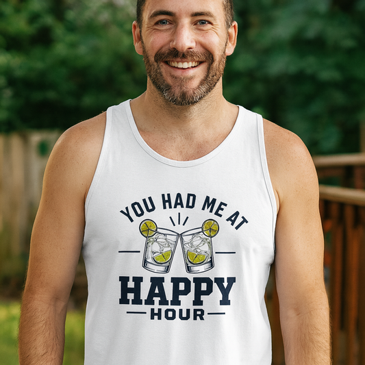 Smiling man in a white You Had Me At Happy Hour tank top standing outdoors